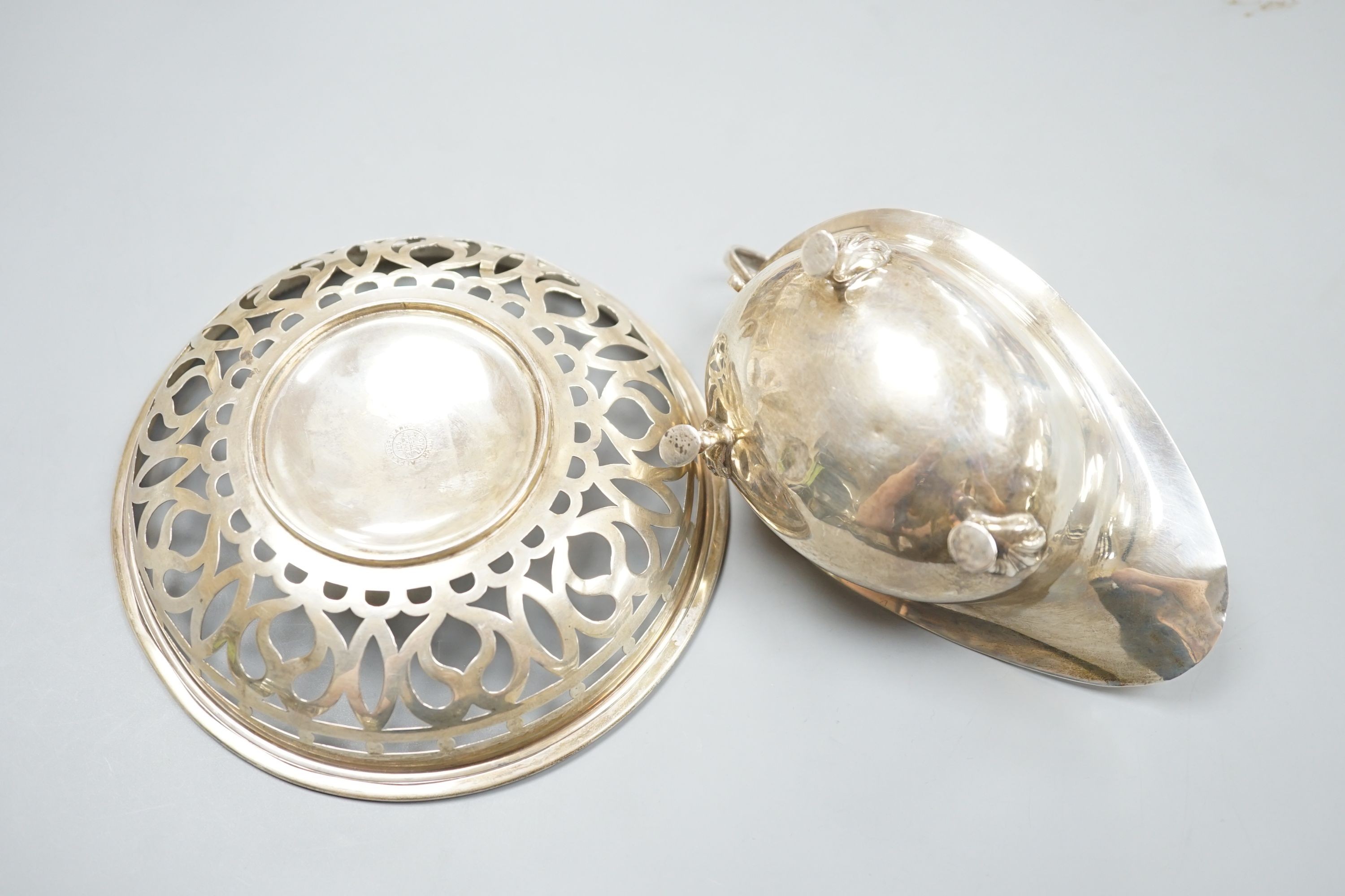 An oval sauce boat with French gadroon rim and flying scroll handle, Birmingham 1918 and a pierced circular bowl with beaded rim, Birmingham 1910, diameter 15.25cm, 207 grams.